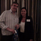 Ralph Warrington, Travel Counsellors collects a bottle of champagne from Jane Bolton from Couples Resorts